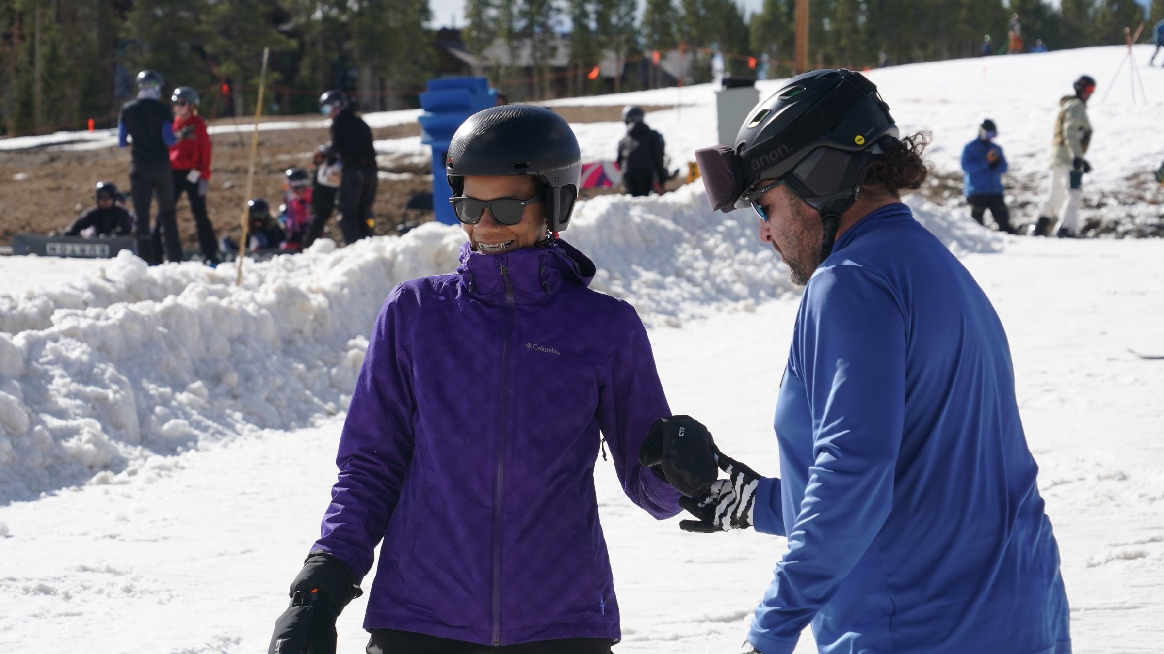Ski instructor helping a new skier
