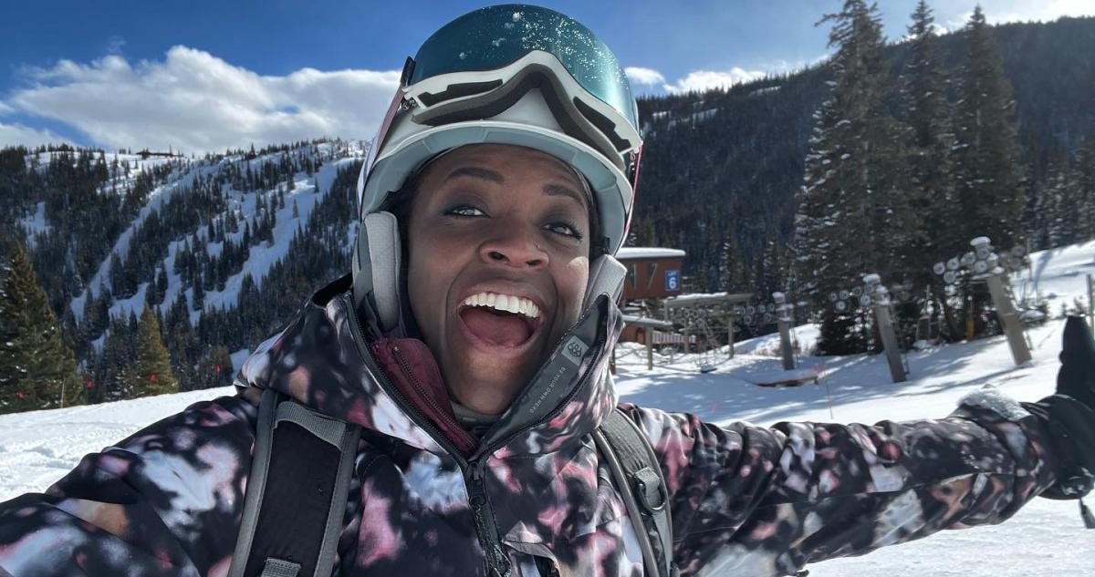 Smiling skier on a sunny mountain